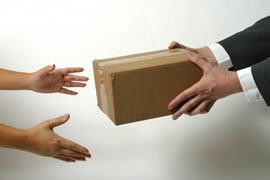 Man handing someone a small box