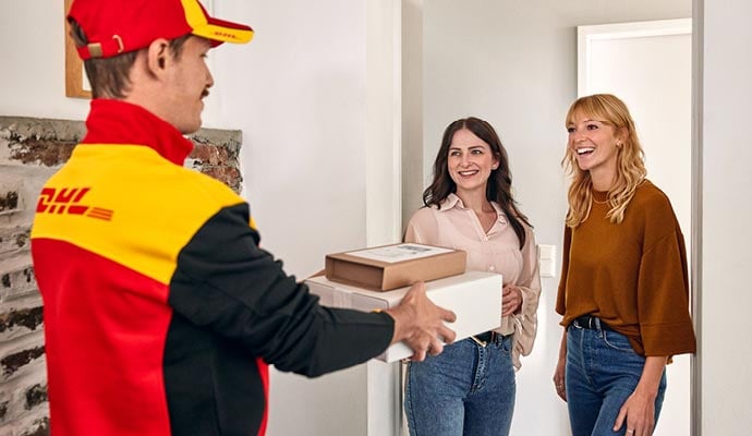 DHL eCommerce UK driver delivers parcel to two young women