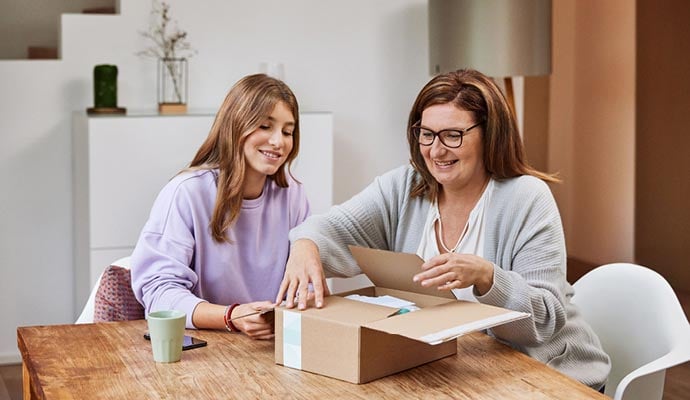 Woman and daughter securely package return to send back to the retailer